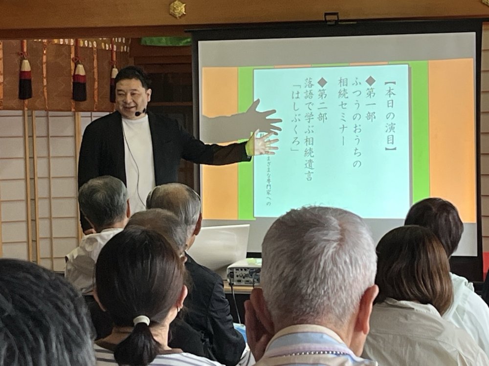 講師の新美善明がスクリーンを示しながら、相続セミナーで参加者にお話ししている様子